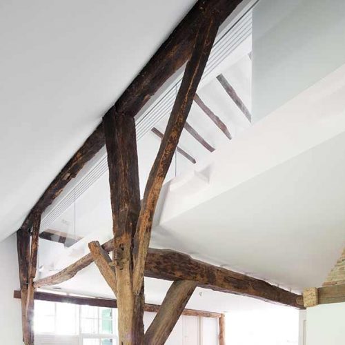 houten balken in het zicht tegen een licht plafond